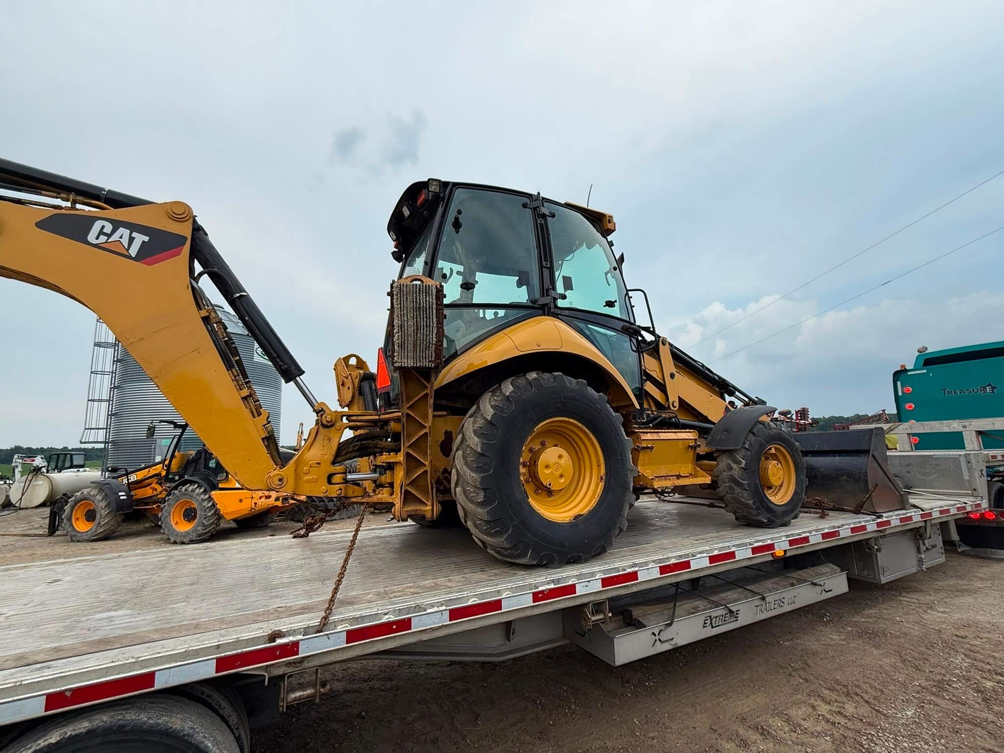 Backhoe being transported on a trailer for heavy equipment shipping